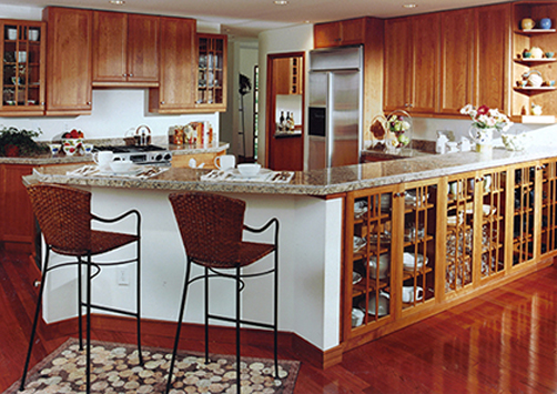 Kitchen design by Stephen Charlip Architect tailored to our clientâs lifestyle.  Wrap around serving counter and custom designed cabinetry to match the house architectural details.